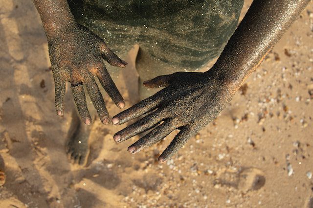 hands of a kid on Hengam Island in Iran