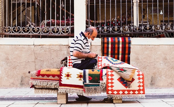 ToIranTour - Man Sellling Persian Carpet in Vakin Bazaar - Shiraz - 10 Days Persian Theme Tour