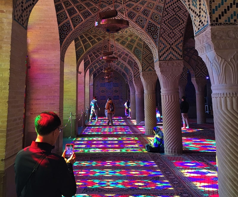 ToIranTour - A tourist taking photos at Nasir al Molk Mosque - Pink Mosque - Shiraz - Iran Classic Tour